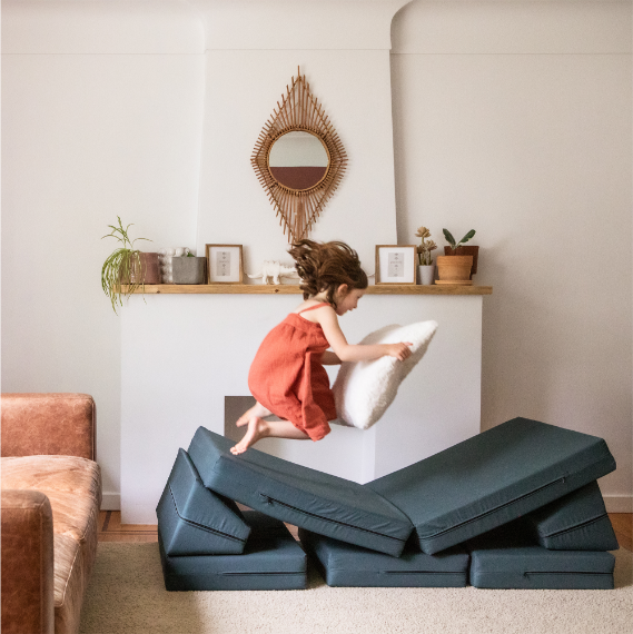 Girl jumping off the couch on Do-A-Lot Blocks